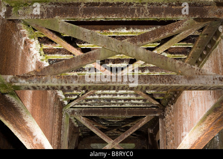 Latticed rusted metal beams forming old bridge decking. Stock Photo