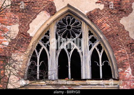 Broken gothic window of old damaged castle. Stock Photo