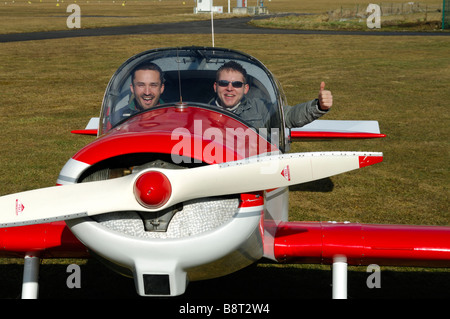 An old french airplane Jodel D-113 (build during fifties) ready to start with 2 young pilots Stock Photo