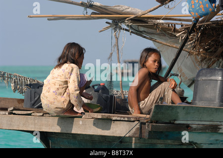 Two young Bajau Laut girls on stern of houseboat Pulau Sibuan Semporna Sulu Sea Malaysia South east Asia Stock Photo