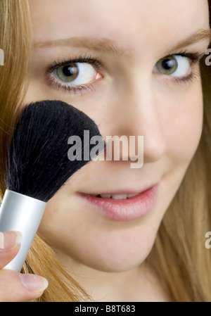 Young woman with a make-up brush in her hand Stock Photo