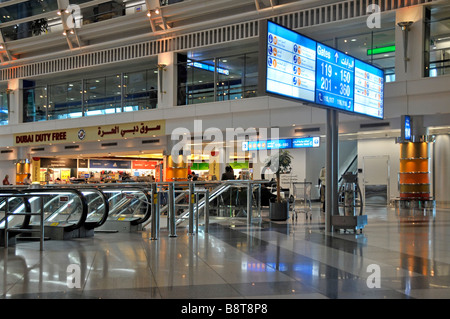 Dubai international passenger airport modern interior departures lounge building gate signs & duty free shop sign United Arab Emirates UAE Middle East Stock Photo