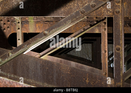 Metal triangles pattern of old bridge beams supporting deck. Stock Photo