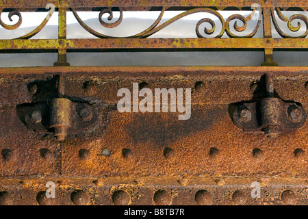 Details of old metal bridge floor and handrail cramps in winter covered with snow. Stock Photo