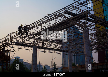 Construction workers welding a scaffolding in Beijing, China. Stock Photo