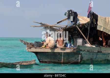 Two young Bajau Laut girls on stern of houseboat Pulau Sibuan Semporna Sulu Sea Malaysia South east Asia Stock Photo