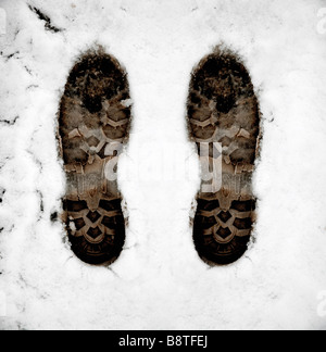 Boot foot prints in the white snow Stock Photo