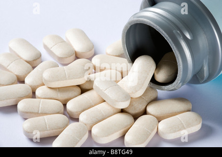 Nutritional supplement tablets (Glucosamine sulphate) spilling from bottle Stock Photo