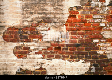 Grunge red brick wall texture with remaining plaster stucco Stock Photo