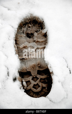 Boot foot prints in the white snow Stock Photo