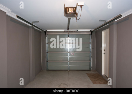 The inside of a garage with an automatic garage door. Stock Photo