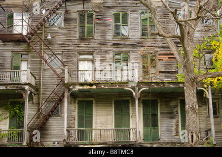 Big old decrepit house with shuttered windows Stock Photo