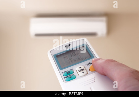 Turning the air conditioner on Stock Photo