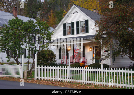 White clapboard house with a white picket fence Stock Photo