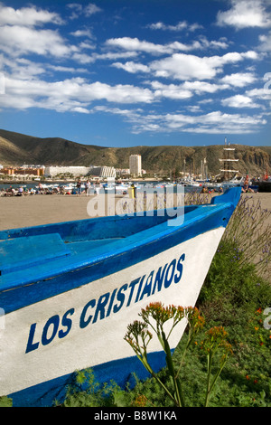 Feature traditional wooden fishing boat named 'Los Cristianos' lying on Los Cristianos beach Tenerife Canary Islands Spain Stock Photo