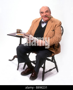 man smiling at camera holding newspaper Stock Photo