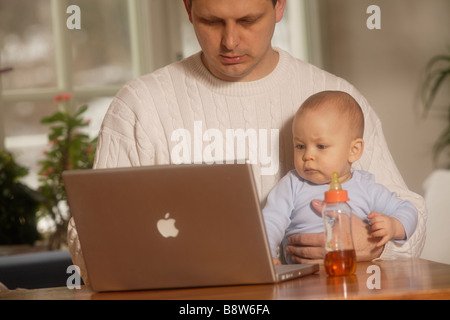 Son Watching Father Work on Laptop Stock Photo