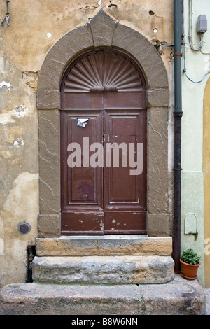 Old & dilapidated doorway in Volterra, Tuscany, Italy Stock Photo