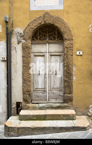 Old & dilapidated doorway in Volterra, Tuscany, Italy Stock Photo