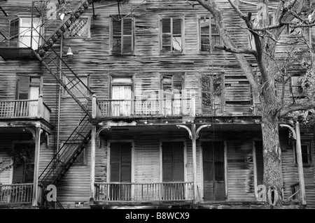 Big old decrepit house with shuttered windows Stock Photo