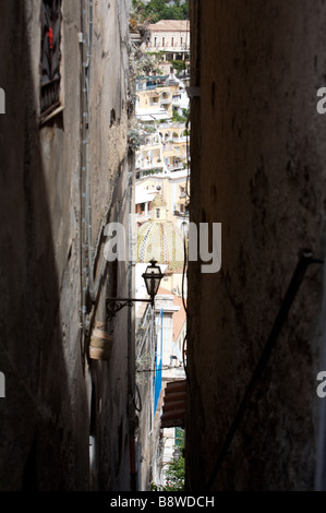 The view of Positano on the Amalfi coast in Italy seen through a gap between two buildings Stock Photo