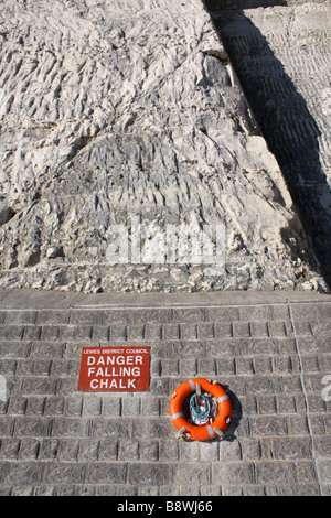 Safety sign Danger Falling Chalk and lifebelt on the Undercliff walk, Peacehaven, East Sussex, England, UK Stock Photo