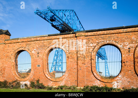 The Transporter bridge in Middlesbrough view through the remaining wall of the old salt works England Stock Photo