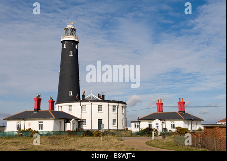 The old lighthouse and white buildings at Dungeness in Kent, UK Stock Photo