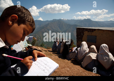 lesson in elementary school in the mountains surrounding Muzzafarabad in Azad Jammu and Kashmir in Pakistan Stock Photo