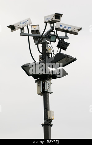 A cluster of CCTV cameras and floodlights mounted on a post in a car park in Worcestershire England UK Stock Photo