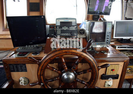 The controls in the wheelhouse of a fishing trawler Stock Photo