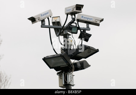 A cluster of CCTV cameras and floodlights mounted on a post in a car park in Worcestershire England UK Stock Photo