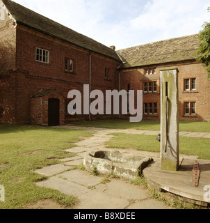 View of Tatton Old Hall from the north east corner showing the Old Hall built around 1520 and the water pump in the courtyard Stock Photo