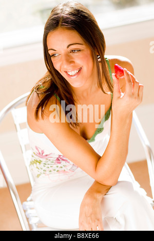 Woman eating a Strawberry Stock Photo