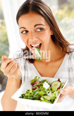 Girl eating salad Stock Photo