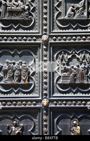 Cast bronze doors of the Duomo (cathedral) in the Piazza del Duomo, Florence, Tuscany, Italy. Stock Photo