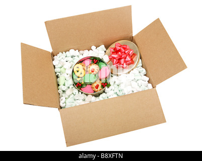 Delicious colorful holiday cookies in a box surrounded with styrofoam peanuts Isolated with clipping path Stock Photo