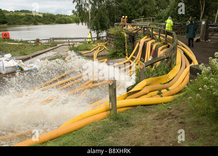 High volume pumps and hoses ease flood water at Ulley Dam during major flooding incident UK Stock Photo