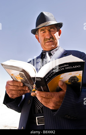 Old man with hat reading a book, Tajikistan, Asia. Stock Photo