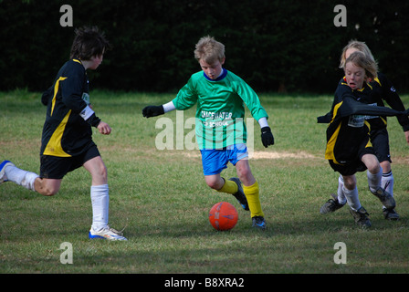 young boys playing football,uk Stock Photo