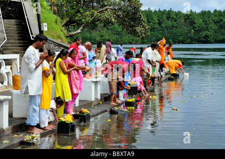 Mauritian family making a offering at a religious ceremony, Grand Bassin, Mauritius island Stock Photo