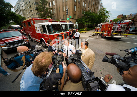TV news teams filming a spokesperson for the DC Fire Department. Fire in Foggy Bottom, 20 & F NW Washington DC. May 2006.