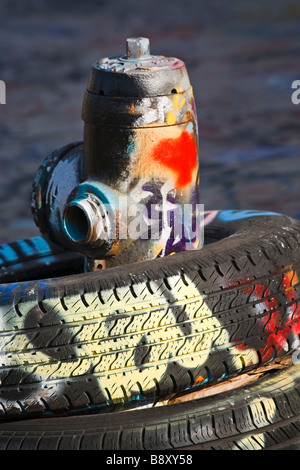 Discarded automobile tires fire hydrant and graffiti Five Points neighborhood Queens New York Stock Photo