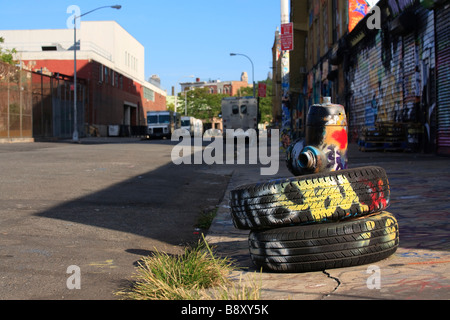 Discarded automobile tires fire hydrant and graffiti Five Points neighborhood Queens New York Stock Photo