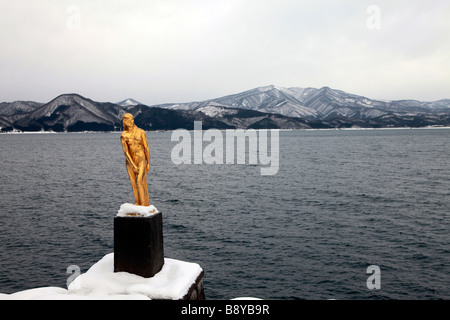 Tazawa ko Lake with golden Tatsuko statue in winter  Akita prefecture Northern Japan Stock Photo