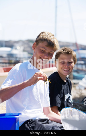 Two boys and a crab Smogen Bohuslan Sweden. Stock Photo