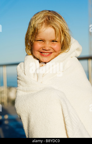 A little Scandinavian girl wrapped in a towel.