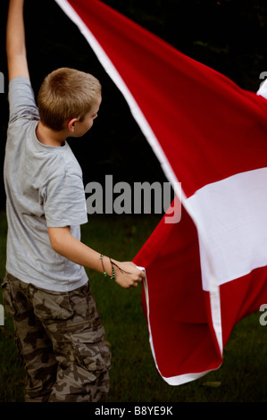 A boy and the Danish flag Denmark.