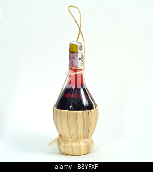 a small chianti bottle of red wine Stock Photo