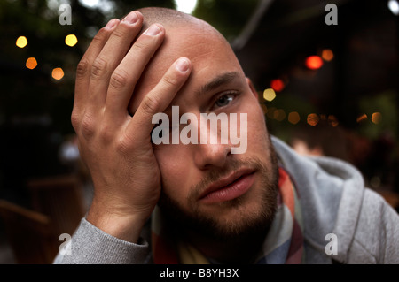 A man with his hands on his head. Stock Photo